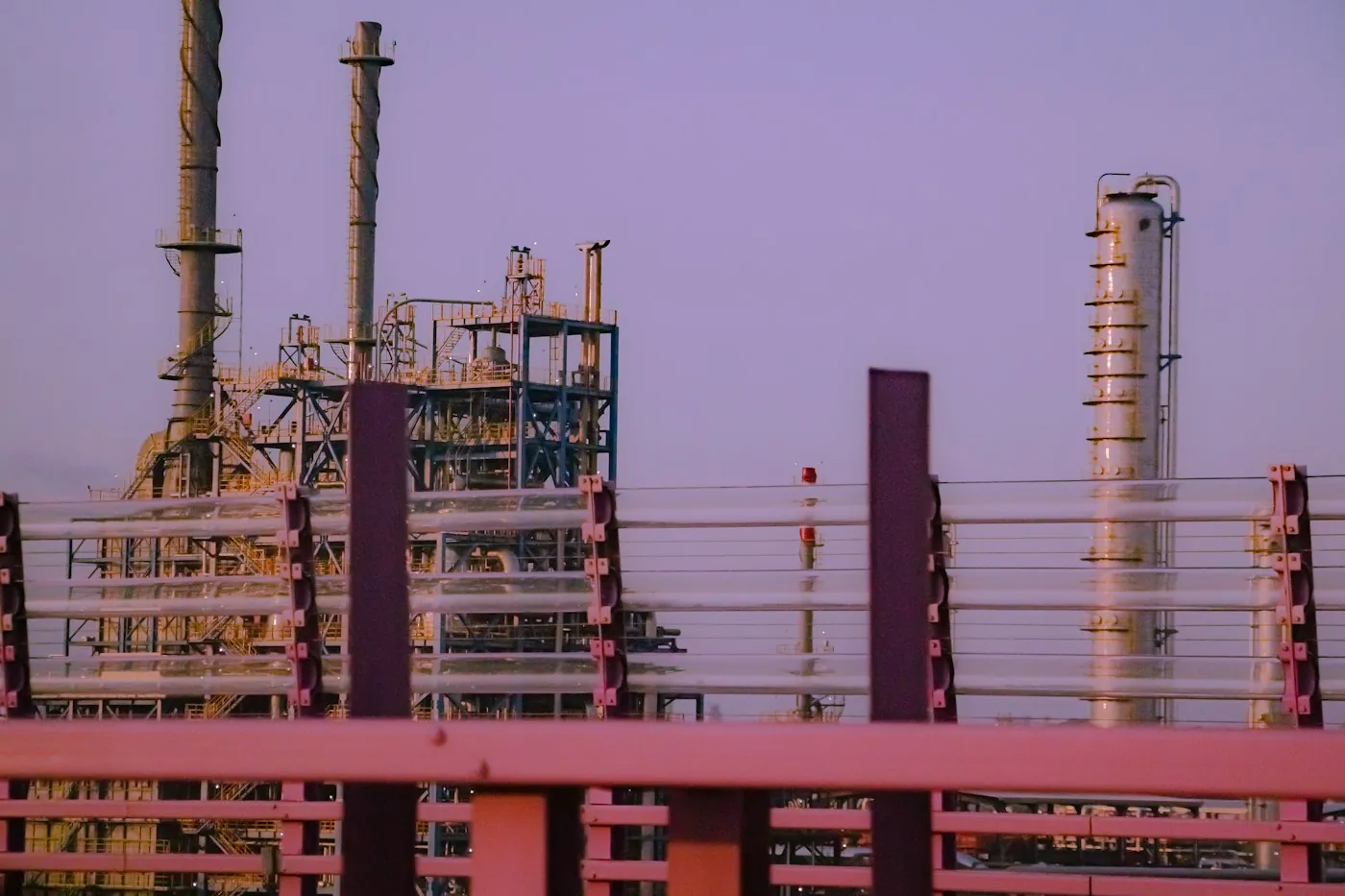 Industrial plant towers against a purple dusk sky